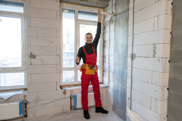 Obraz na płótnie Canvas Builder handyman with construction tools. House renovation background.