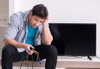 Man trying to fix broken tv