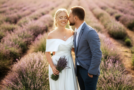 bride and groom on in the lavender field