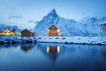 Wall murals Reinefjorden View on the house in the Sarkisoy village, Lofoten Islands, Norway. Landscape in winter time during blue hour. Mountains and water. Travel - image