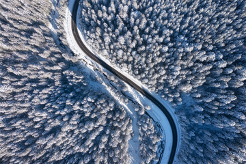 Natural winter landscape from air. Aerial view on the road and forest at the winter time. Winter...
