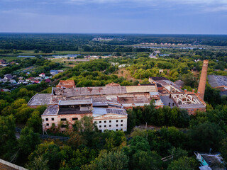 Fototapeta na wymiar Ruined overgrown abandoned sugar factory in Ramon, aerial view