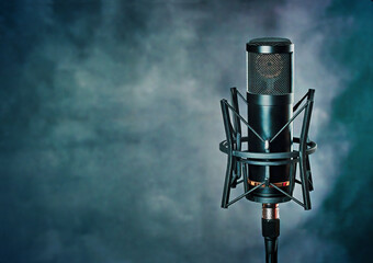 Vocals studio mic, in a grunge blue background. Professional equipment on a music template, with copy space for text