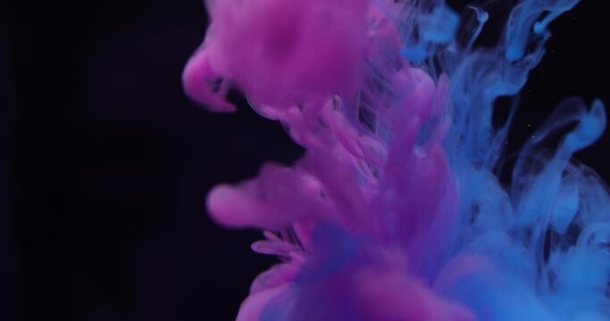 Abstract color ink behind black background