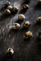 Quail eggs scattered on a wooden surface