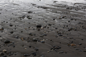 Smooth Pebbles on Wet Beach