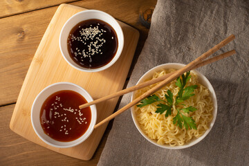 noodles in a bowl with sauce and herbs