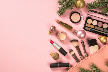 Make up products with cosmetic bag and christmas decorations. Idea for christmas sale and presents. Flat lay image with copy space.