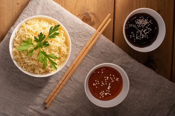 noodles in a bowl with sauce and herbs