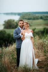 bride and groom on in the woods