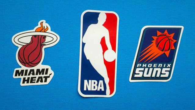 October 1, 2021, Springfield, USA, Emblems Of The Miami Heat And Phoenix Suns Basketball Teams On A Blue Background.