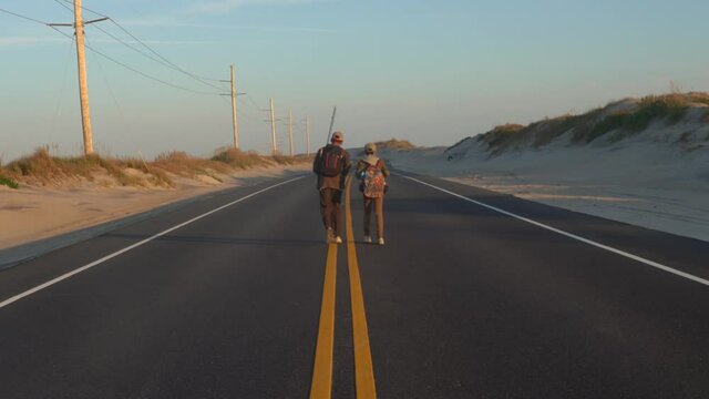 Two Boys Walking Along Abandoned Highway