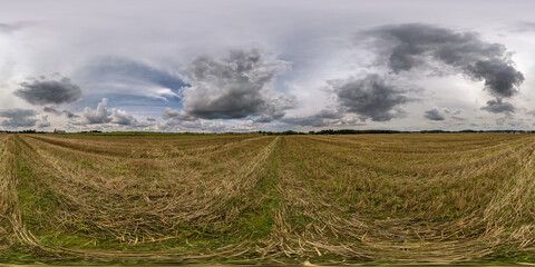 360 seamless hdri panorama view among fields with clouds in blue sky before storm in...