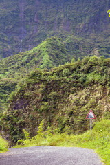 Tahiti. Mountain road and steep descent warning sign