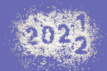 Rice flakes with old 2021 and new year 2022 numbers, sprinkled rice flakes. Color of the year 2022. purple, lavender, lilac