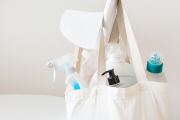 Textile eco bag and plastic packages with household chemicals in it.