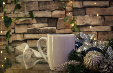 Christmas background ideal for gift cards with spheres and plants and a coffee mug