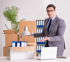 Young handsome businessman moving offices