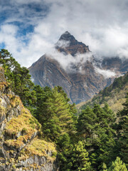 view from valley to triangle summit in clouds in sunny day in Nepal