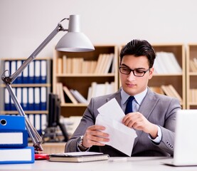 Businessman receiving letter envelope in office