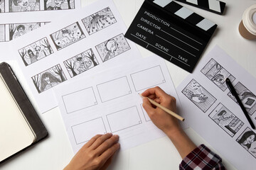 The artist draws a storyboard for the film. The director creates the storytelling by sketching...