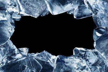A frame made of broken pieces of ice. Ice chunks with a hole in the middle isolated on a black background. - obrazy, fototapety, plakaty