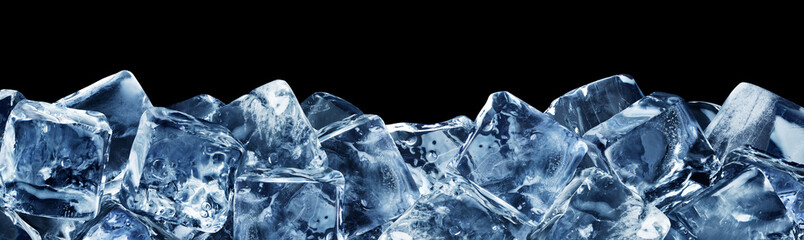 Natural ice cubes, poured horizontally at the bottom, isolated on a black background.
