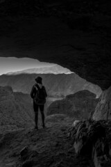silhouette of a person at a cave