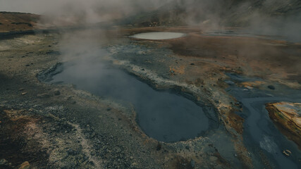 Empty geothermal Krysuvik area on Reykjanes peninsula in Iceland on early summer morning. Visible sulphur rising from the ground.