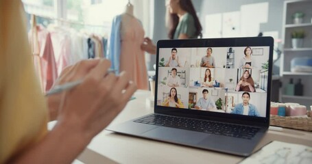 Close-up young Asia lady dressmaker use laptop on meeting with multi graphic designer team discuss sample create dress design new collection on desk in shop. Tailor new business startup concept. - Powered by Adobe