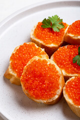 Sandwich with red caviar and butter close-up