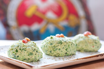 Phali is a traditional dish of Georgian cuisine made of spinach, vegetables and walnuts on the background of the flag of Georgia from the USSR