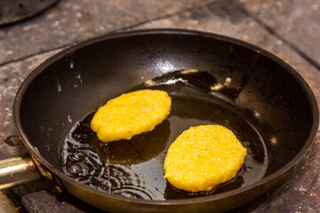 Potato patties are fried in a frying pan with oil