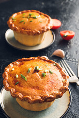 Tasty beef pot pie on dark background