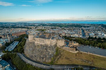 Stunning aerial view of Edinburgh in Scotland, with the royal castle occupying commanding position on volcanic crag with cliffs on three sides and the fourth side facing the capital city Edinburgh