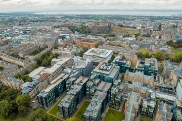Obraz premium Edinburgh aerial top view. The neo-gothic structures of Edinburgh’s historic castle form silhouettes against the sky, providing a romantic view that has attracted visitors for years.