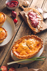 Tasty beef pot pies with meat on table