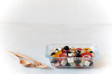 Greek salad in a glass container, concept of eating at work