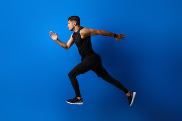 Fototapeta premium Sporty male runner on color background