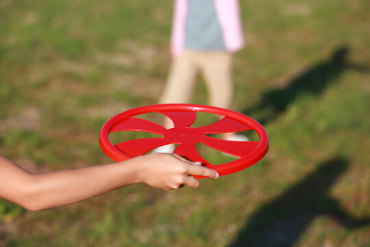 Cute little children playing frisbee outdoors