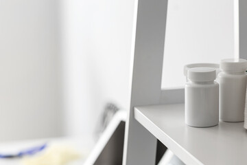 Medical bottles on shelf in doctor's office, closeup
