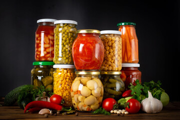 Jars with pickled vegetables and fruity compotes. Preserved food