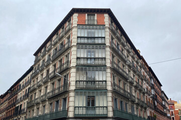Fototapeta na wymiar Street corner, old building with balconies