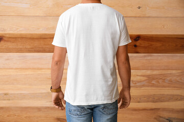 Handsome man in white t-shirt on wooden background