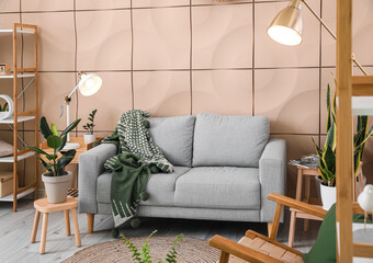 Interior of modern living room with grey sofa and glowing lamps