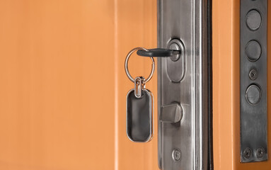 Obraz premium Key inserted in door hole, closeup
