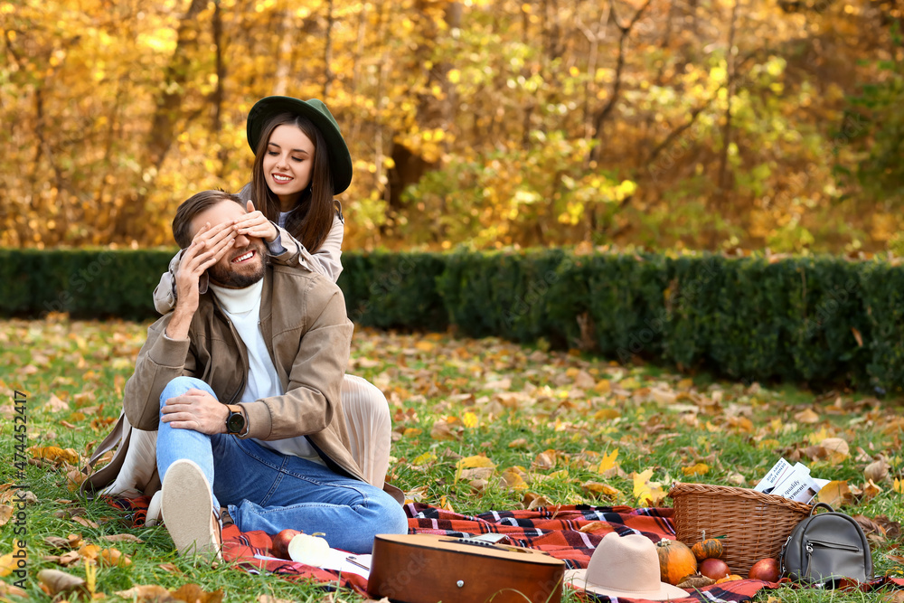 Sticker Young woman closing eyes to her beloved in autumn park