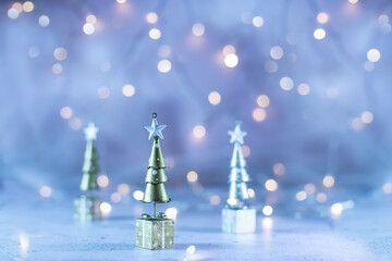 Christmas trees on festive background with blurred lights