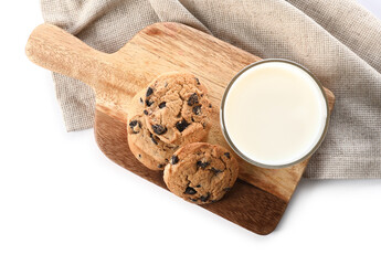 Board with tasty homemade cookies and glass of milk on white background