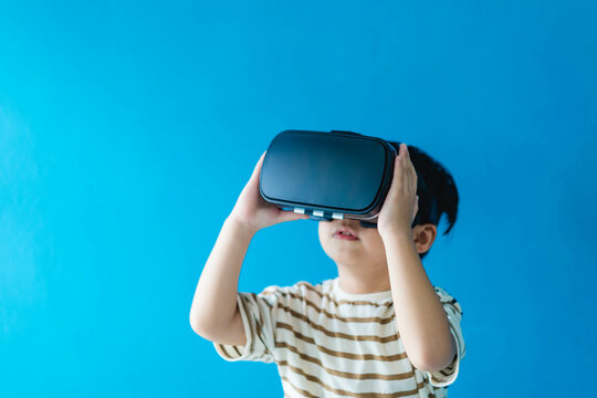 kid child toddler boy playing game on virtual reality vr glasses.future digital technology. kid toddler boy play VR virtual.future technology.Online learning education student with innovation tech.